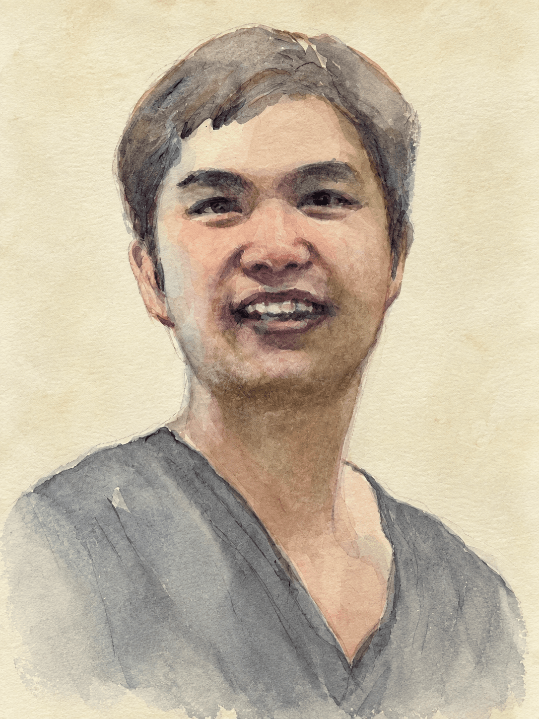 Smiling frontal portrait in a gray V-neck