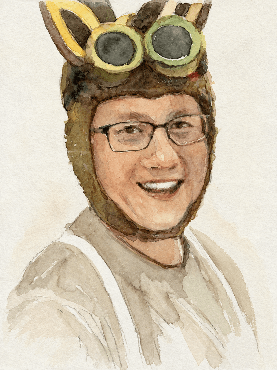 Smiling portrait with glasses and goggles atop the head