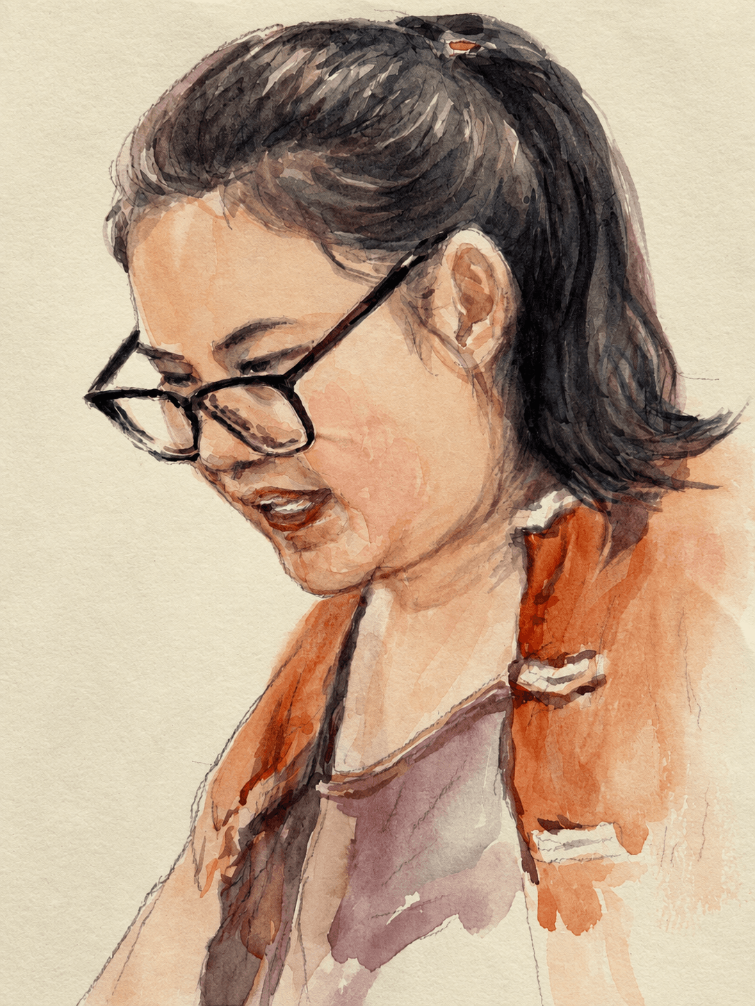Downward-looking portrait with glasses and an orange scarf
