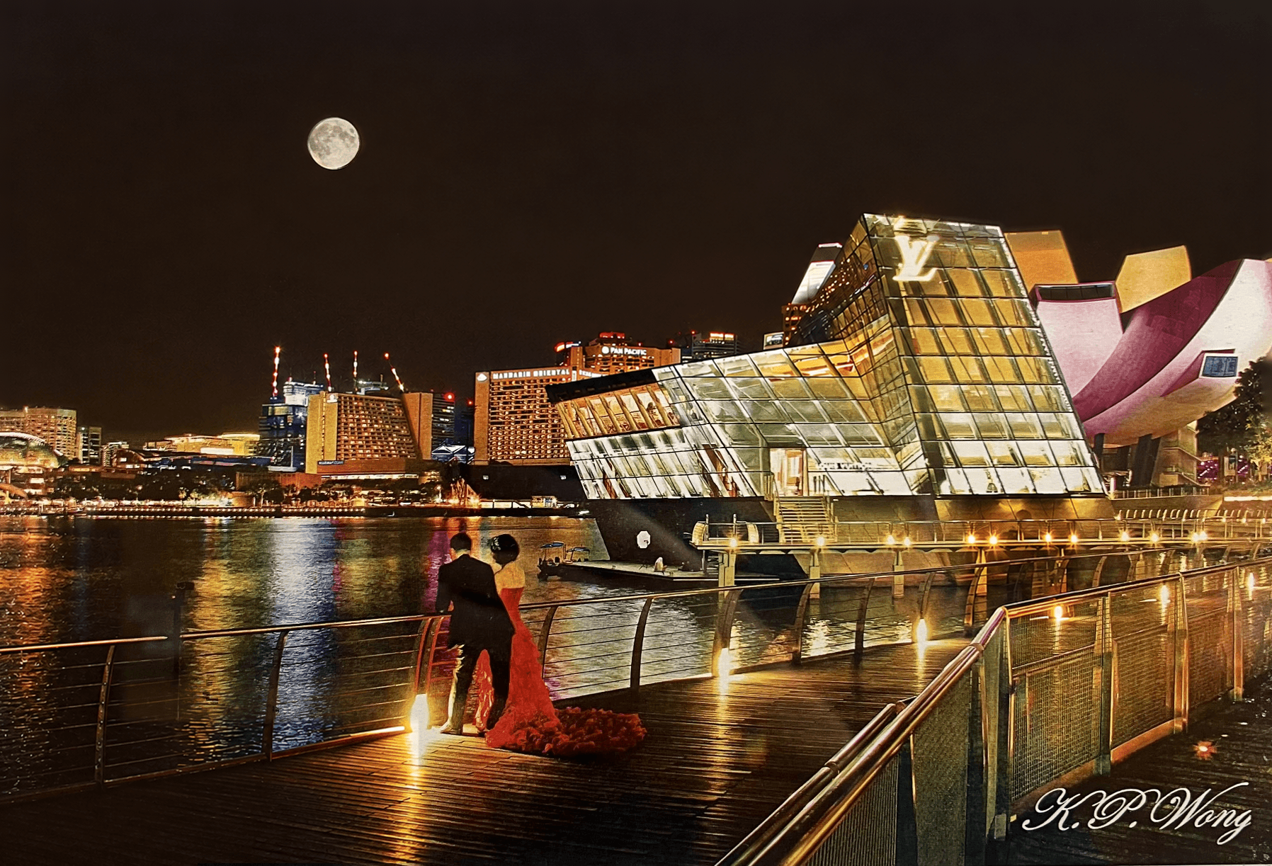 Night Marina Bay boardwalk with couple in red gown facing Louis Vuitton pavilion and full moon
